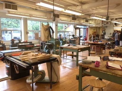 Technisch atelier in een high school in Canada met werkbanken en gereedschap, beeld van praktijkonderwijs.